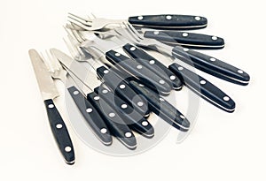 Close up six knives and forks isolated on white background