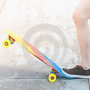 Close-up skateboarder girl with skateboard outdoor at skatepark