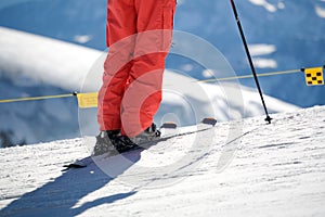 Close up of ski and trousers and ski pole