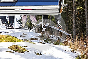 close-up of skiers on a ski lift going to the slope for a ride.