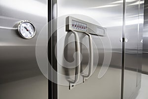close-up of a sleek and modern walk-in freezer, with metal handles and digital temperature controls