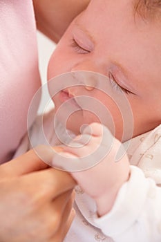 Close Up Of Sleeping Baby Boy Holding Mothers Hand