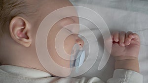 Close Up Of A Sleeping Baby Sucking A Pacifier