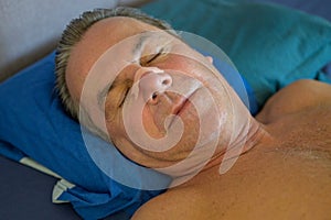 Close up of a sleeping man with a nose tape