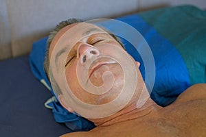 Close up of a sleeping man with a nose tape and a mouth tape