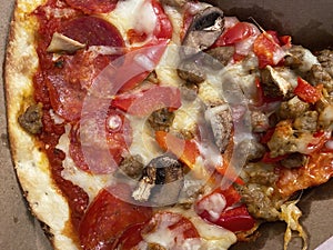 Close-up Slice of Supreme Pizza Carryout photo