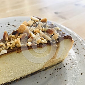 Close up of a slice of walnut cheesecake, select focus on walnuts.