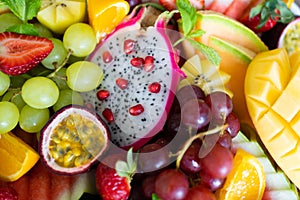 Close up sliced assorted fresh tropical fruits platter,use a background