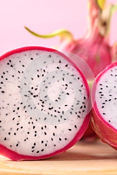 Close up of sliced dragon fruit or pitaya on wooden