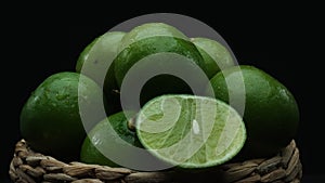 Close up of sliced lime, vibrant citrus slice are contain in basket. Comestible.