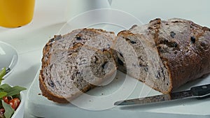 Close-up of sliced rye raisin bread on the white cutting board