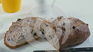 Close-up of sliced rye raisin bread on the white cutting board