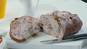 Close-up of sliced rye raisin bread on the white cutting board