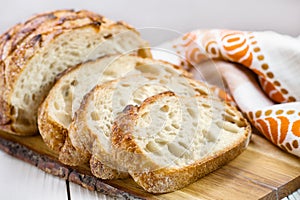 Close up of sliced wheat bread on board selective focus