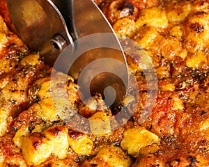 Close-up of slicing an Italian pizza. Traditional food from Palermo, Sicily, Italy. Ingredients Tomato sauce, anchovy, onion,