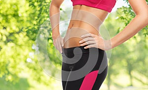 Close up of slim fit woman`s body with trained abs