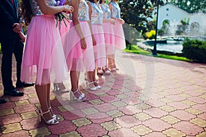 Close up of slim legs of woman wearing high heel shoes.