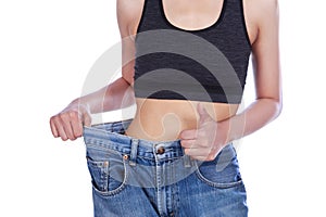 Close up slim woman in old jeans showing thumbs up isolated on w