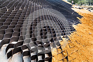 Close up of slope erosion control with grids and earth on steep slope