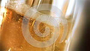 Close-up slow-motion cold light beer in a glass with water drops on bar background. Craft Beer close up. Microbrewery