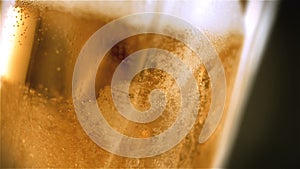 Close-up slow-motion cold light beer in a glass with water drops on bar background. Craft Beer close up. Microbrewery