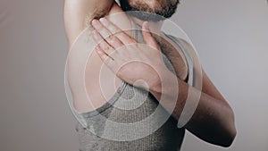 Close up slow motion shoot of man touching his hairy armpit with wet sweat spots and showing thumb up. Refusal of depilation, shav