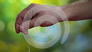 Close-up slow motion video of men`s hand with salt on the kitchen