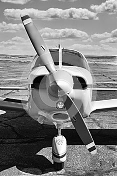 Close up of small commuter plane and prop om the tarmac