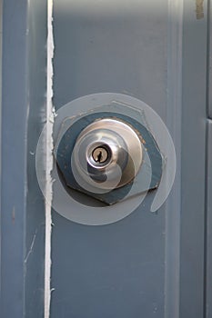 Close-up of a small doorknob and keyhole on a door