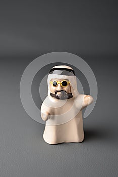 Close up of small figure of Emirati man.