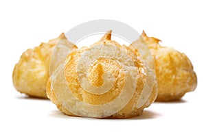 Close up of small hollow profiteroles isolated on white background