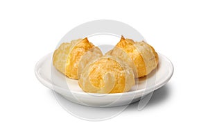 Close up of small hollow profiteroles on plate isolated on white background