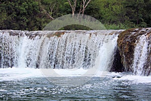 close up of a small waterfall while boating the Zrmanja river inland from Obrovac, Croatia