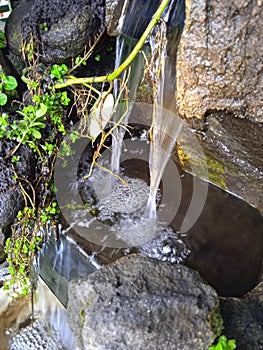 Close up small waterfall fish pond