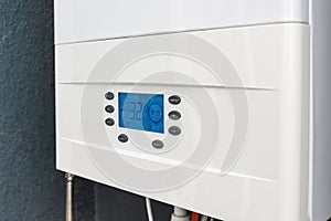 Close up of smart control panel of gas boiler for winter home heating and hot water. Modern house device