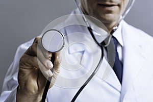 Close up of smart doctor holding stethoscope