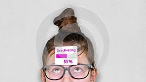 Close-up, a smart teenager face, a child in glasses, with a sticker on his forehead. an animation of Deactivating