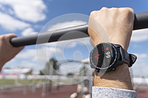 Close-up of smart watch health tracker with heart rate shown on the screen. Modern stylish and innovation wearable device. athlete