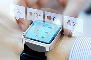 Close up of smart watch with social media icons