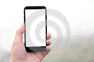 Close-up of smartphone with mockup in man hand.