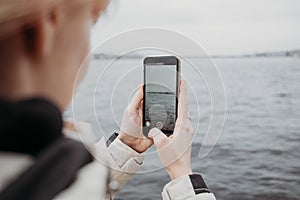 Close up of smartphone taking photo of beautiful tourist landscape in Sant-Petersburg