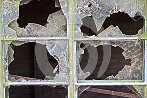 Close up of smashed panes of glass in a window