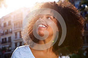 Close up smiling african american woman outside in city