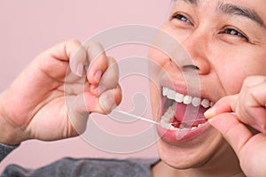 Close-up of smiling asian woman and cleaning for perfect smile. Healthy white teeth by flossing, oral health and dental care