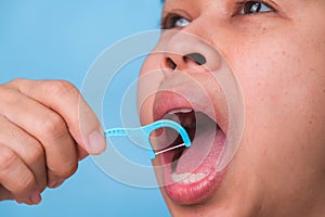 Close-up of smiling asian woman and cleaning for perfect smile. Healthy white teeth by flossing, oral health and dental care