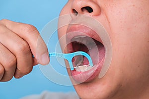 Close-up of smiling asian woman and cleaning for perfect smile. Healthy white teeth by flossing, oral health and dental care