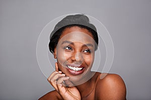 Close up smiling black woman with hand to face and bare shoulders