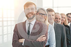 close up. smiling business people standing in one after another.