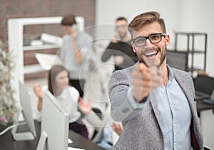 Close up. smiling businessman pointing finger at you