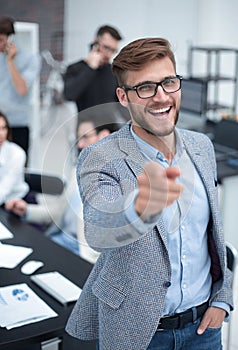 Close up. smiling businessman pointing finger at you